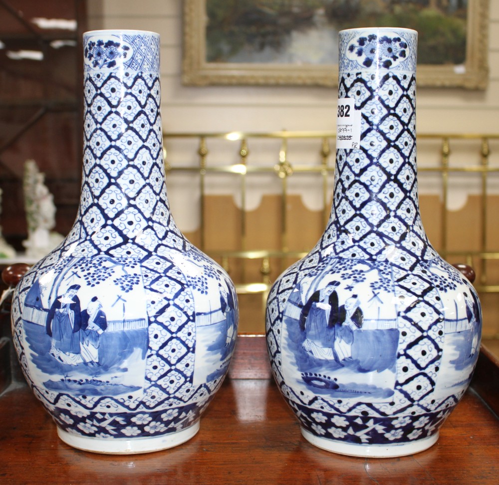 A pair of 19th century Chinese blue and white vases, decorated with panels of figures in gardens, four character marks, height 34.5cm